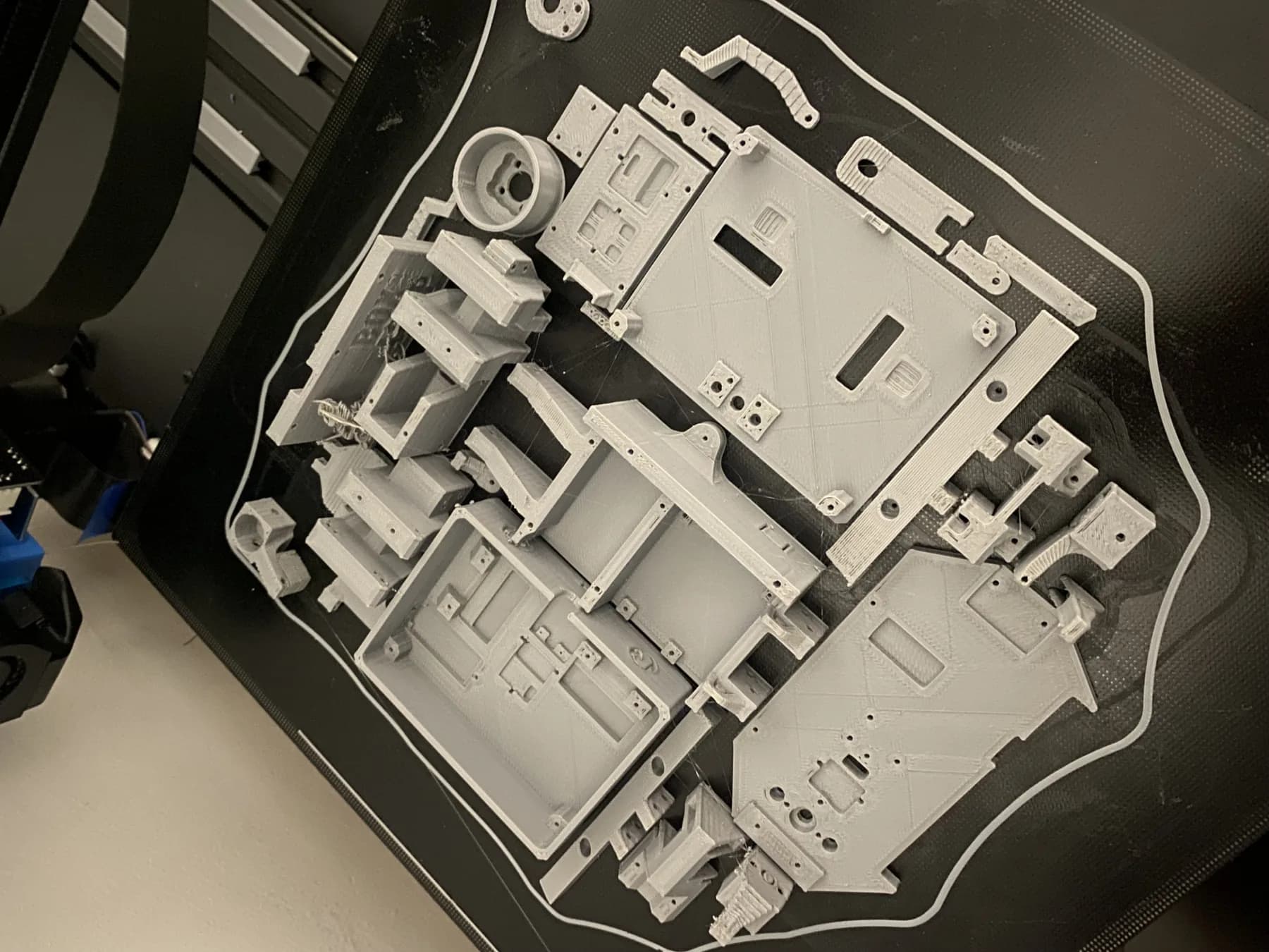 Batch of prototype components on a 3D printer bed